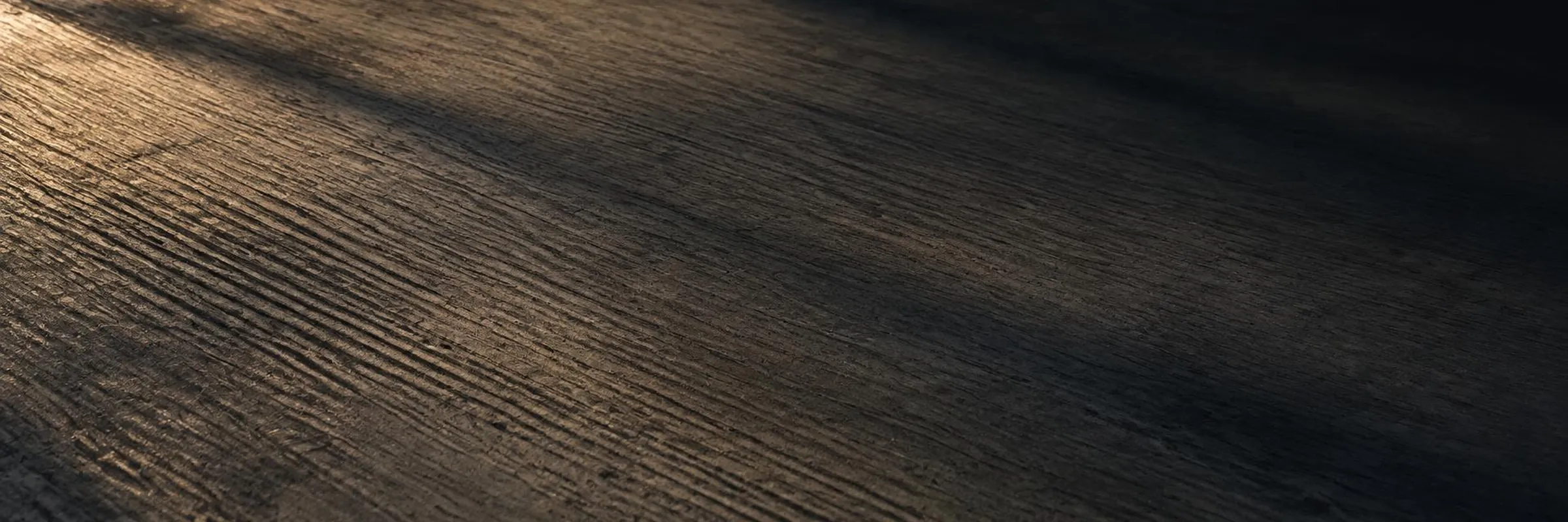 Illustrative image: close-up of a broom-textured concrete surface in low evening light